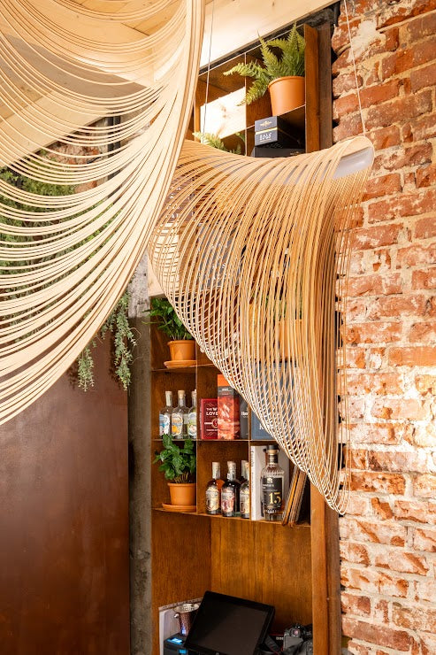 WineMine spirits shelf with woven hanging lights
