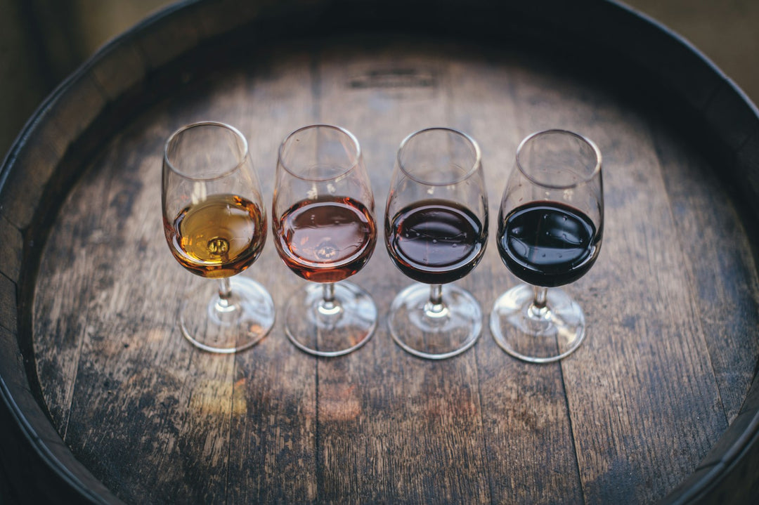 Wine flight on a wooden barrel showing dessert wine