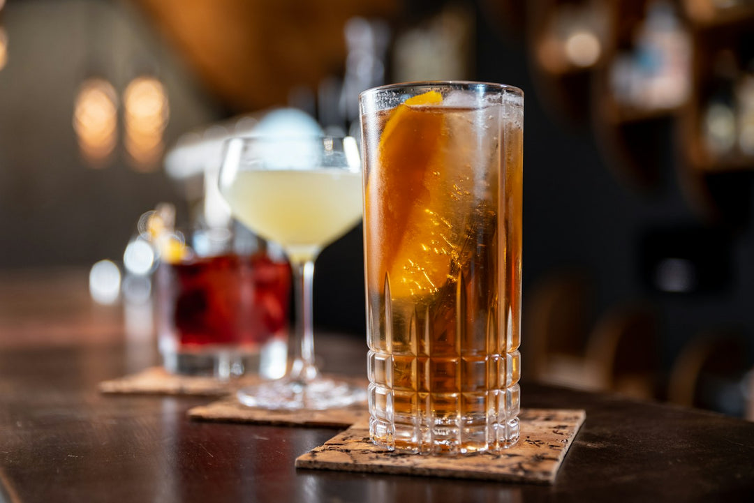 Cocktails on a bar with orange garnish