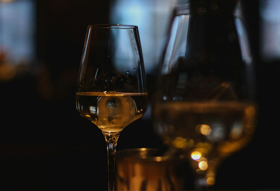 White wine glass in dim bar lighting
