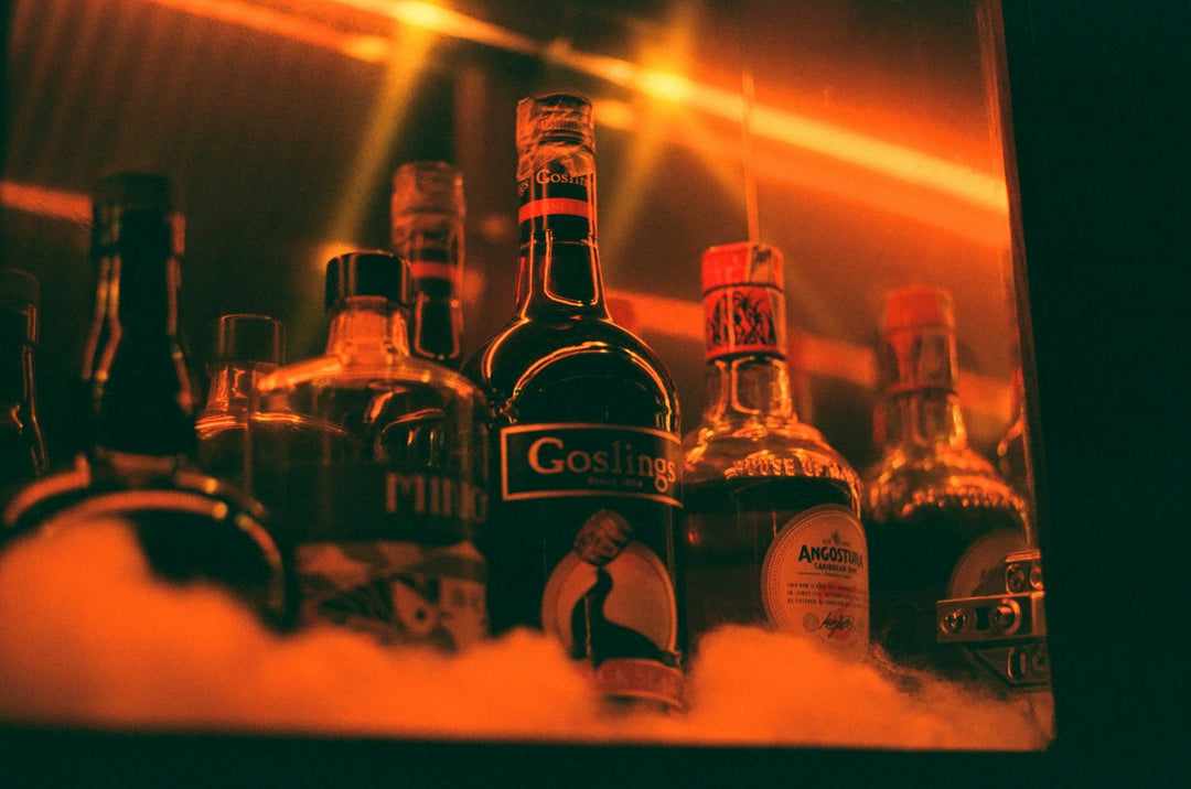 Spirits bottles on ice with warm orange backlight